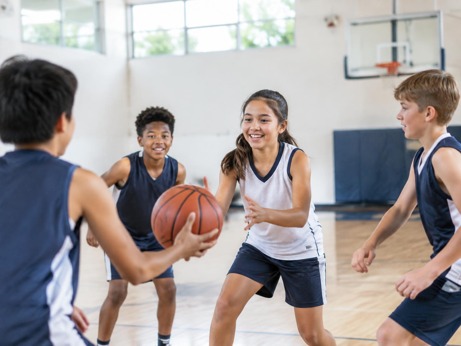 Kids playing basketball together at a team practice